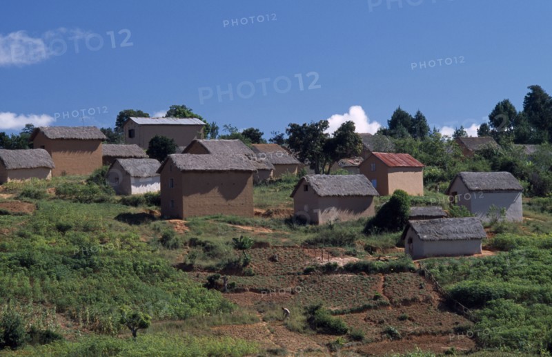 MADAGASCAR, Architecture, Road to Ambalavao. Thatched huts set into hillside