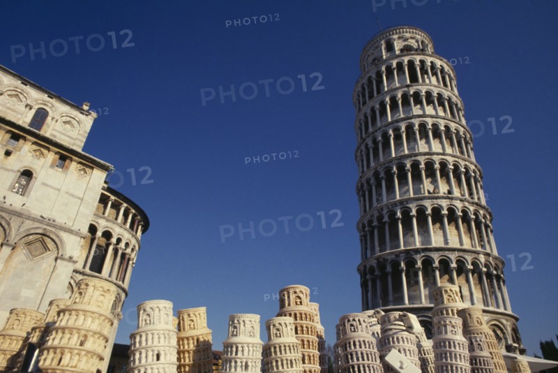 ITALY, Tuscany, Pisa, The Leaning Tower with souvenir models displayed in foreground.