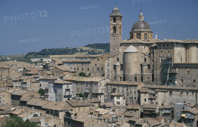 ITALY, Marche, Urbino, Palazzo Ducale rising above city rooftops.  Built for Duke Federico da  Montefeltro the ruler of Urbino between 1444 and 1482.