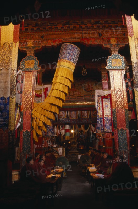 CHINA, Tibet, Monks chanting in the main chapel of Gonggar Chode Monastery near Lhasa Airport.