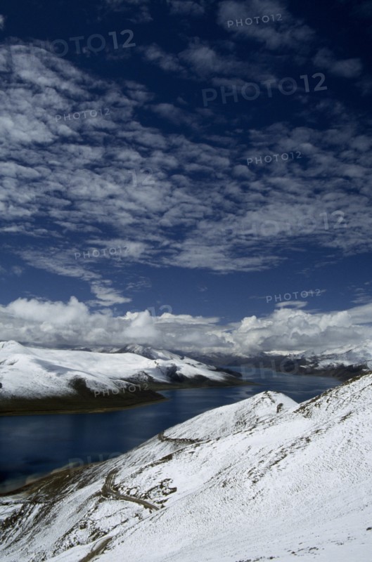 CHINA, Tibet, Yamdrok Tso, "The Turquoise Lake, with snow covered hills, seen from the summit of the Khamba La."