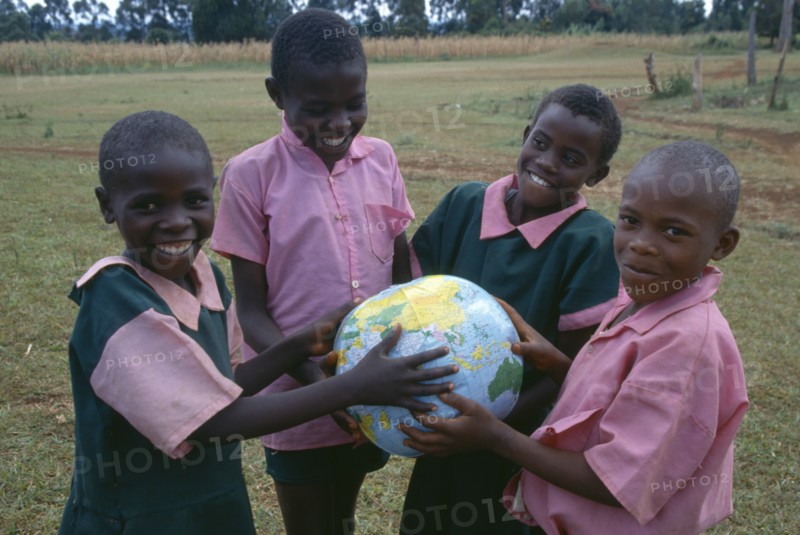 KENYA, Education, Schoolchildren holding a globe.
