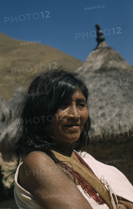 COLOMBIA, Sierra Nevada de Santa Marta, Kogi Tribe, Portrait of older woman wearing necklace of precious red glass beads.
