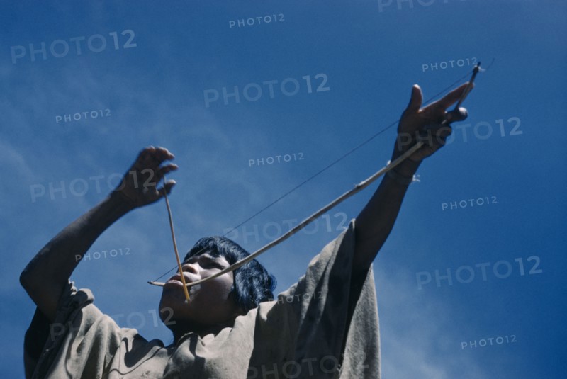 COLOMBIA, Sierra de Perija, Yuko - Motilon , Portrait of woman playing musical bow.  The Yuko-Motilon are very musical with a wide range of musical instruments and syncopated war chants.