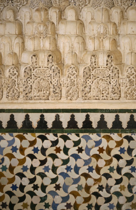 SPAIN, Andalucia, Granada, The Alhambra.  Detail of stucco and tiles