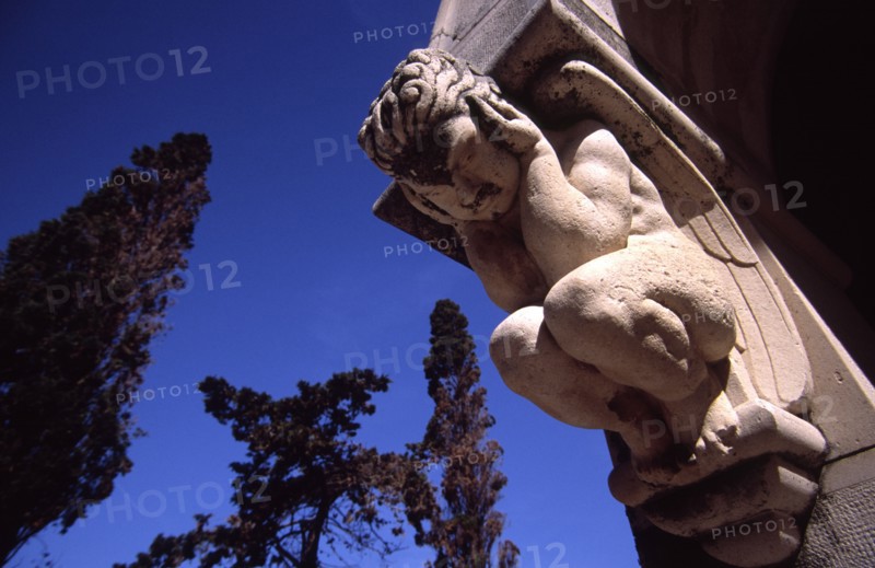 CROATIA, Dalmatia, Brac, "Supetar Petrinovic mausoleum/sculpted angel. Toma Rosandic, contemporary of the great Croatia sculptor Ivan Mestrovic, fashioned this sublime mausoleum for the local Petrinovic family which lies in the town cemetary on the wooden cape of Saint Nicholas just outside Supetar"