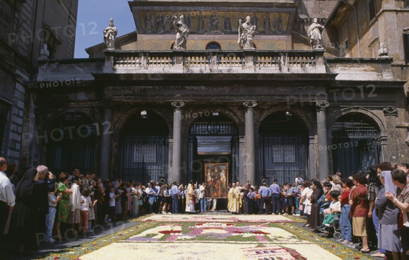 ITALY, Lazio, Rome, Santa Maria in Trastevere Basilica with crowds gathered for display of icon and flower petal mosaic during Infiorata di Gerano.