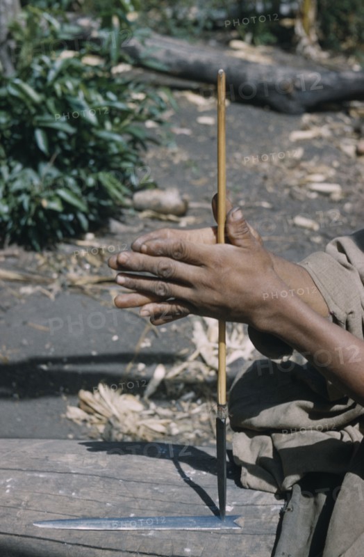 COLOMBIA, Sierra de Perija, Yuko - Motilon ., Man drills hole in base of steel arrow-head for attachment to bamboo shaft
