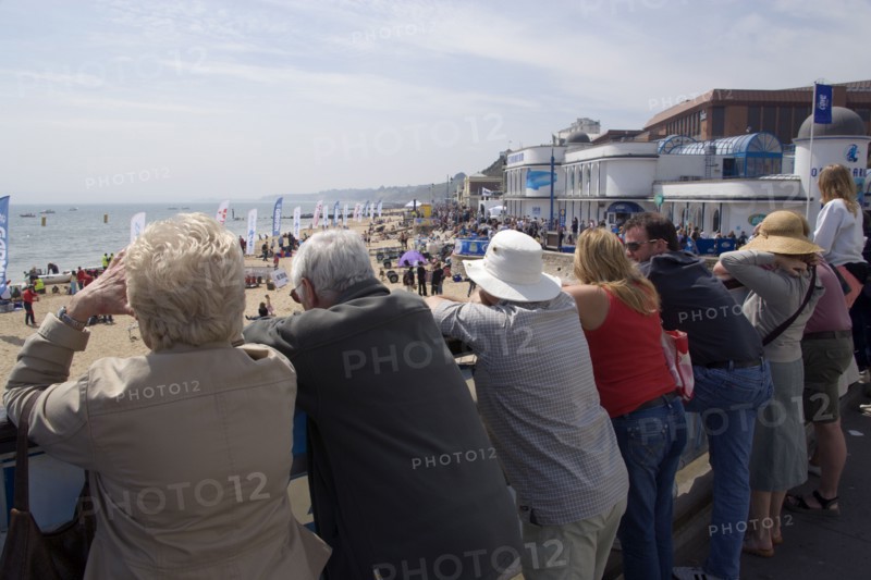 ENGLAND, Dorset, Bournemouth, Tourists watching speedboat races off the West Beach with the Oceanarium and BICC Bournemouth International Conference Centre on the right