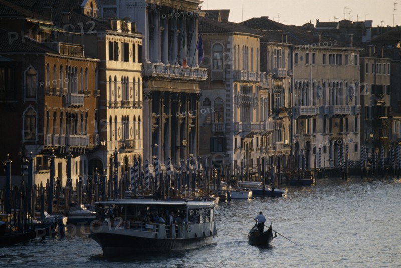ITALY, Veneto, Venice, Crowded vaporetto or waterbus and gondola on the Grand Canal near Rialto Bridge.