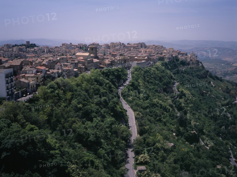 ITALY, Sicily, Enna Province, "A road leading to the city , view West over the rooftops from Castello di Lombardia. The highest provincial capitol in Italy"