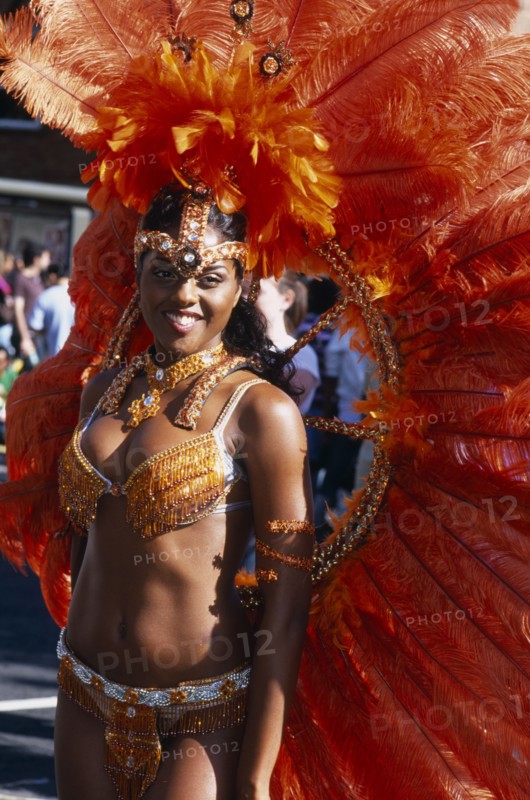 ENGLAND, London, Notting Hill carnival female reveller in extravagant costume