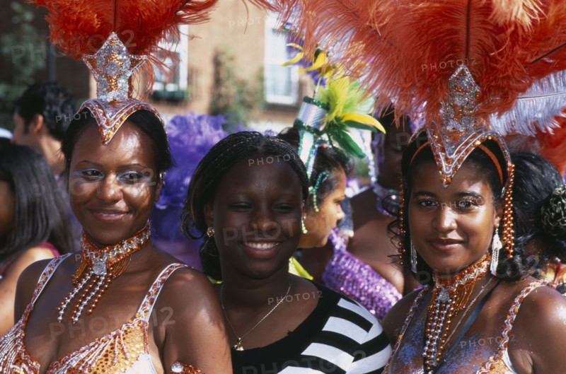 ENGLAND, London, Notting Hill carnival three women revellers.