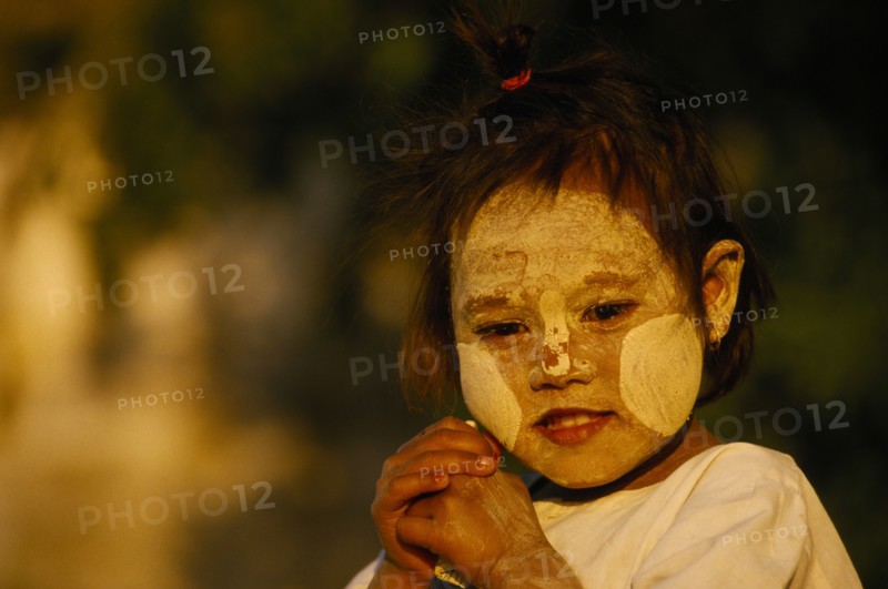 MYANMAR, Pagan, "A young girl near Bupaya Pagoda, with white painted face, circles on her cheeks."