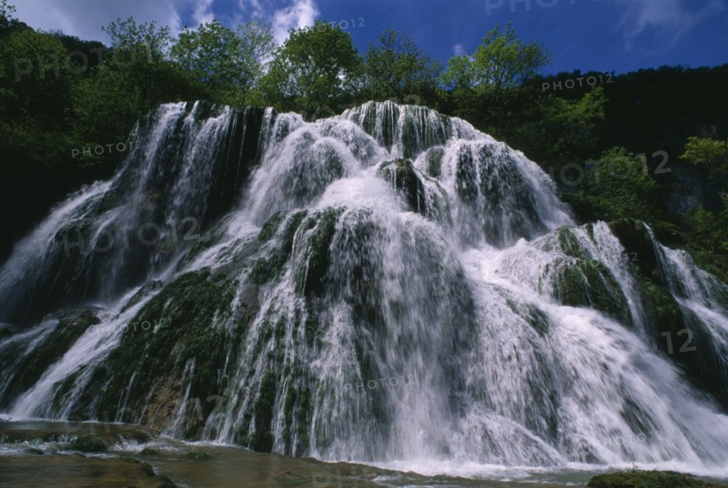 FRANCE, Franche Comte, Ciaquc de Baume, Jura. Waterfall cascading over rocks