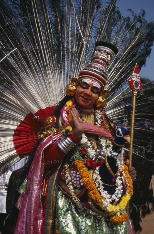 INDIA, Kerala, Thrissur, "Mayura Nritham, Peacock Dance, dancer in costume and painted face, at The Great Elephant March festival."