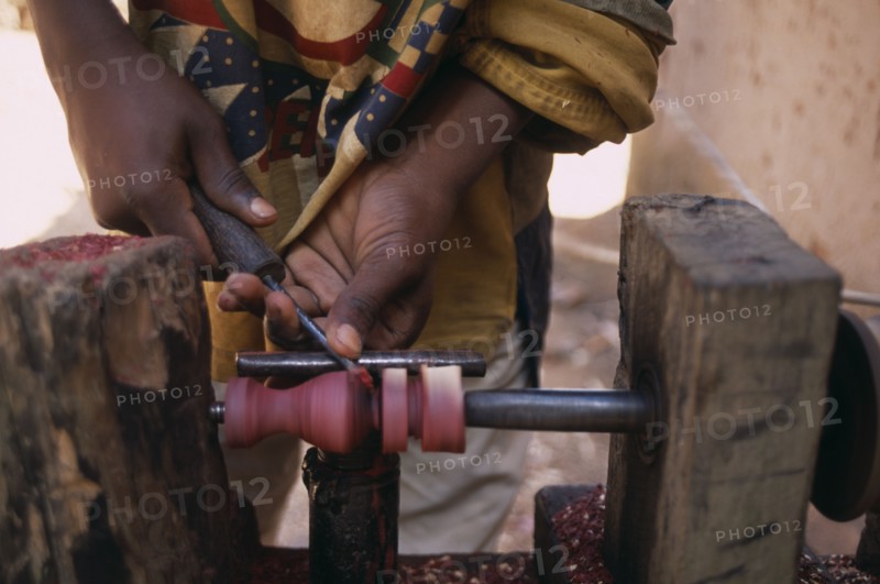 MADAGASCAR, Ambositra, Close up of the hands of an Artisan carving a piece of rosewood