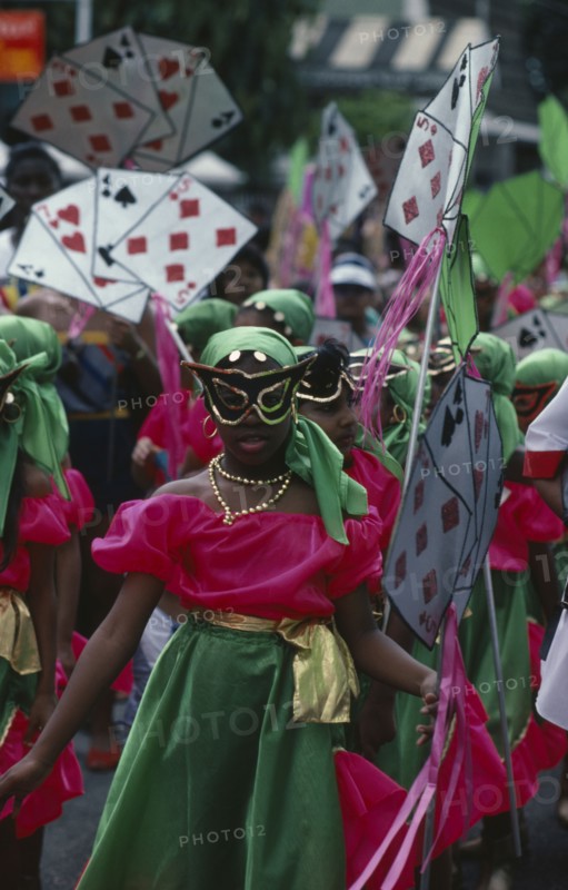 TRINIDAD, Festivals, Carnival precession with girls dressed in pink and green costumes holding large plain card props