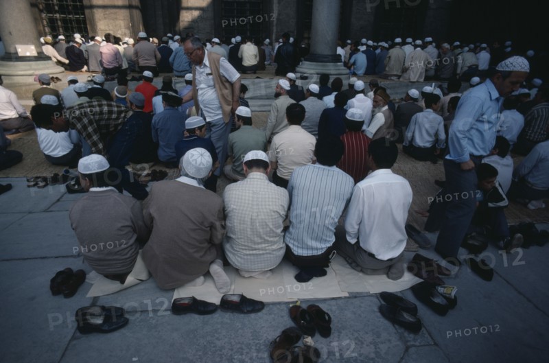 TURKEY, Istanbul, Muslim men and boys at prayer at the Sultan Ahmet Cami or Blue Mosque.
