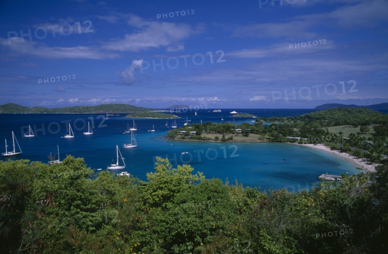 DOMINICA, Landscape, Elevated view over beach and coastline with tree covered Islands and bays on the Atlantic with yachts on the water