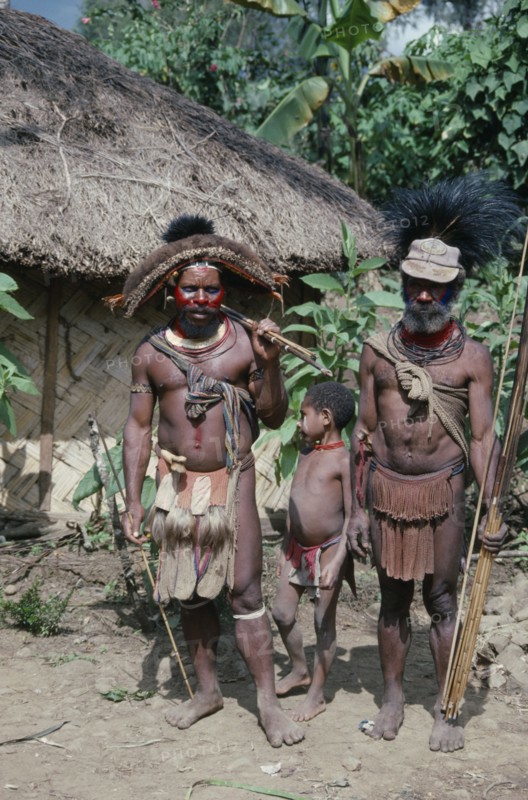 PACIFIC ISLANDS, Melanesia, Papua New Guinea, Southern Highlands.Tari. Huli tribemen with a child holding cane