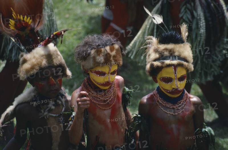 PACIFIC ISLANDS, Melanesia, Papua New Guinea, Southern Highlands. Huli Tribe The Wigmen. Children in costume with painted faces at Sing Sing Festival