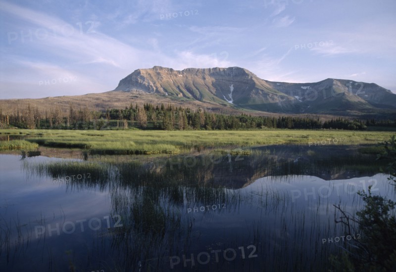 CANADA, Alberta, Waterton Lakes N.P., Landscape with Sofa Mountain reflected in lake.