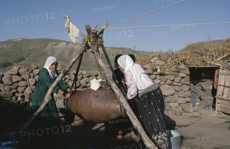 TURKEY, East, Women churning milk in rural area.