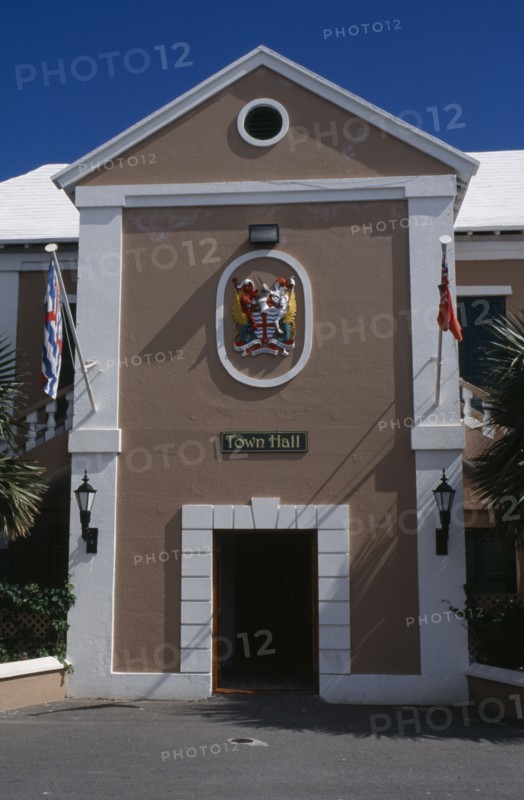 BERMUDA, St George, Kings Square. Town Hall exterior with crest above door  entrance and flagpoles either side