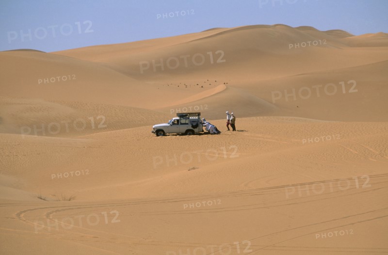 LIBYA, Sahara Desert, Tourists four by four vehicle stuck in Saharan sand.