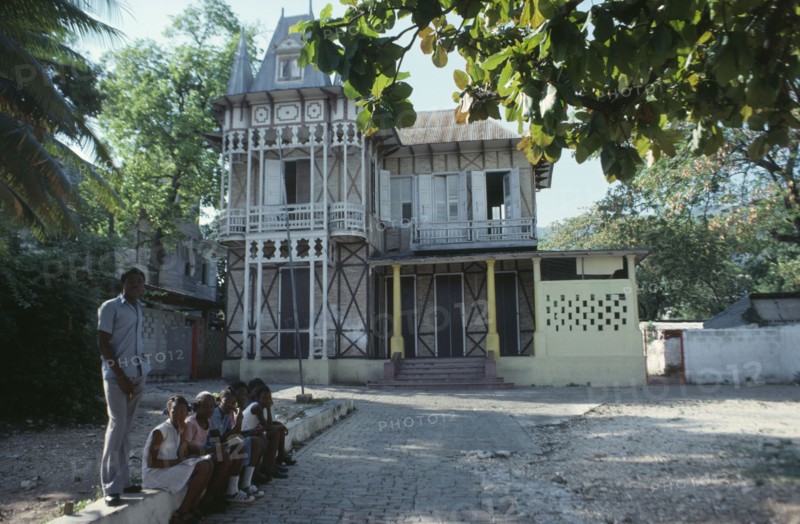 HAITI, Achitecture, Typical domestic architecture.  Colonial style home with children sitting outside.