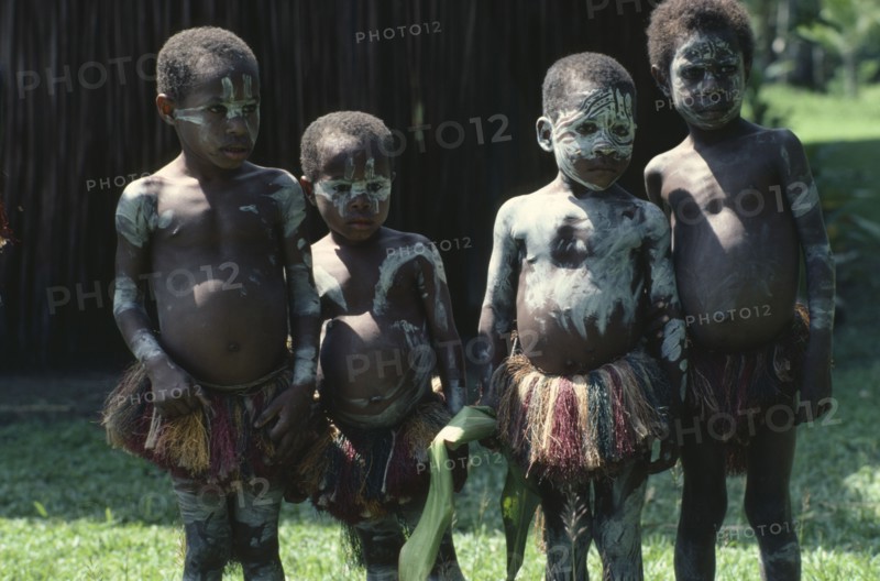PAPUA NEW GUINEA, Children, Sepik children wearing body paint and grass skirts.
