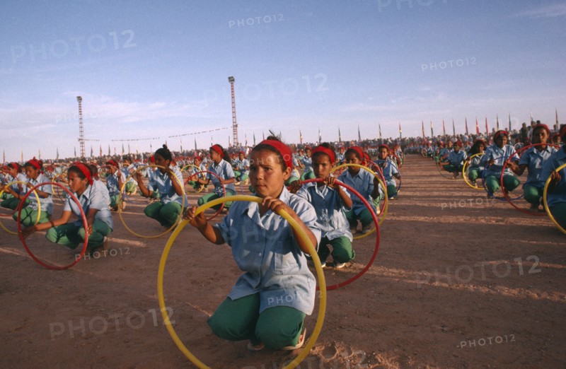 WESTERN SAHARA, SADR, "Parade of children with coloured hoops celebrating anniversary of the Polisario Front, the Sahrawi movement working towards independence."