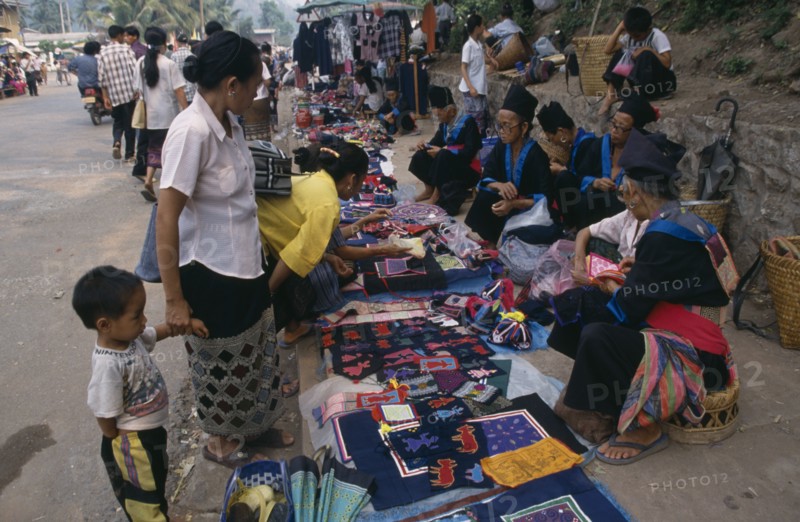 LAOS, Luang Prabang, Hmong market vendors with colourful textile stalls