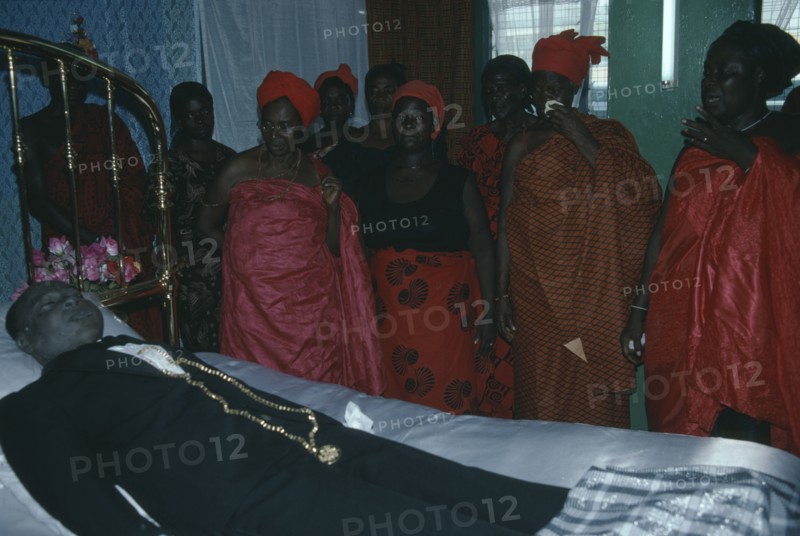 GHANA, Accra, Funeral of man from the Ga community.  His wife talks to her dead husband as is customary during the wake.