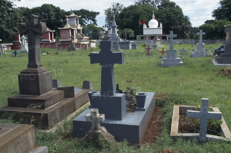 MAURITIUS, General, Crosses alongside Chinese and Islamic tombs in graveyard near Port Louis.