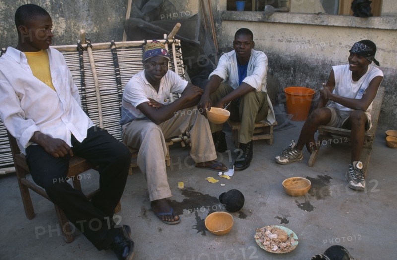 GHANA, North, Drinks, "Boys drinking pito, an alcoholic beverage made from millet or sorghum malt and commonly drunk from shared bowls. "