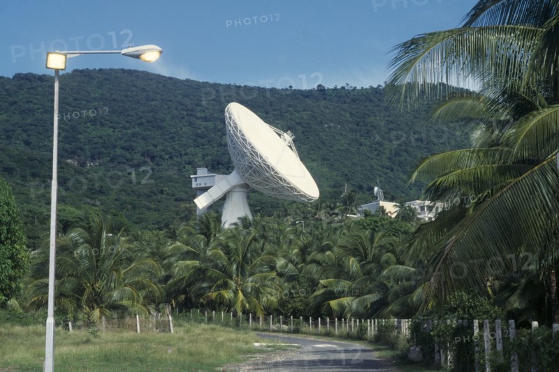 JAMAICA, Media, Satelite earth station.  Satelite dish above palm trees.