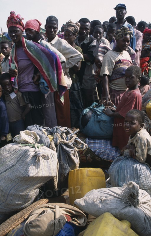 GUINEA, Kissidougou, Camp for Sierra Leonean Refugees. People with sacks moving camp