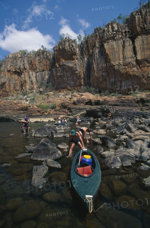 AUSTRALIA, Northern Territory, Nitmiluk National Park, Katherine Gorge canoeists landing boats on the bank of the river which cuts through the sandstone plateau