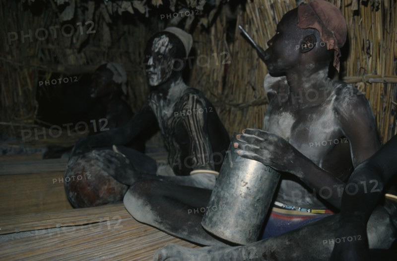 SUDAN, People, Boys, Dinka boys fattening themselves for eight weeks in preparation for manhood.