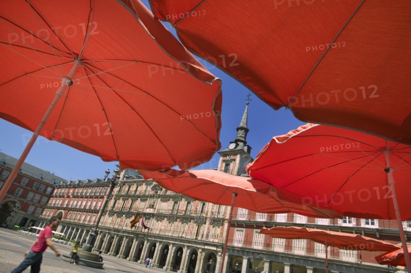 SPAIN, Madrid, "Red restaurant parasols in Plaza Mayor, Main Square."