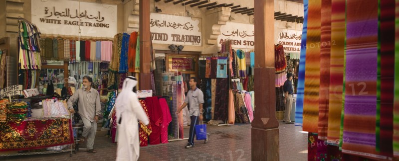 UAE, Dubai, Fabric traders and shoppers in Bur Dubai Souq.