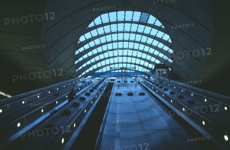 ENGLAND, London, Canary Wharf Underground station escalators and glass roof.