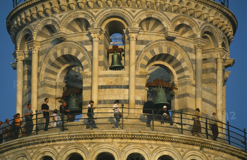 ITALY, Tuscany, Pisa, Campanile or Leaning Tower of Pisa.  Detail of top level and bells with visitors circling gallery.
