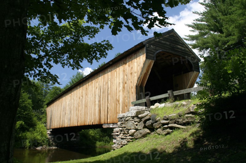 USA, New Hampshire, Newport, "Corbin Bridge, wooden covered bridge, going over water."