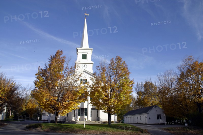 USA, New Hampshire, Dublin, "White church with clock on spire and tall columns at entrance,  golden leaves on trees."