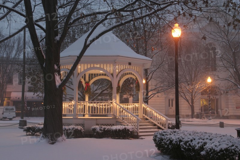 USA, New Hampshire,  Keene Common, "Gazebo or band stand in early morning snowstorm, Christmas Decorations, lampposts."