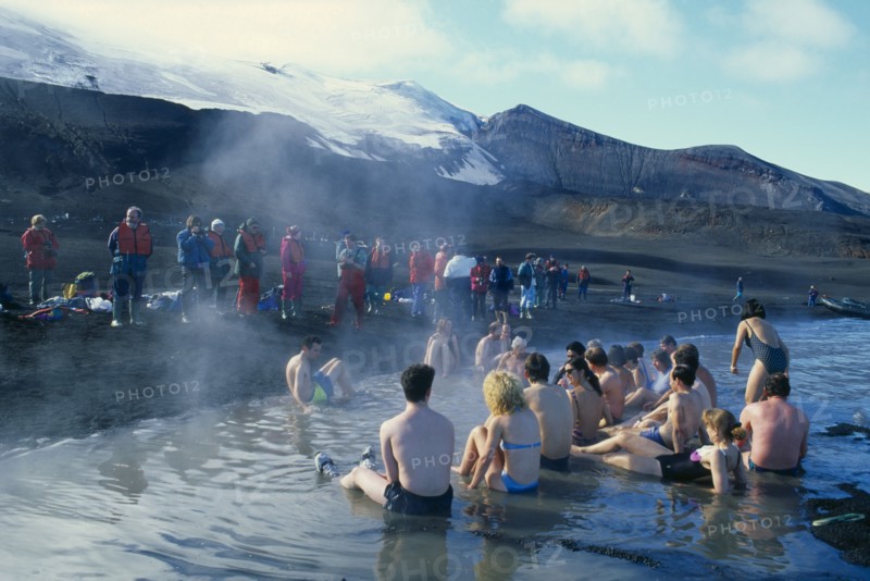 ANTARCTICA, Antarctic Peninsula, Deception Island, Tourists bathing in hot springs at Pendulum Cove.