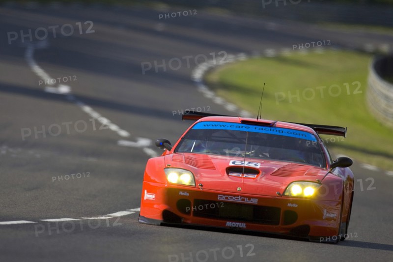 FRANCE, Le Mans, "Number 65 Red Prodrive Ferrari 550 Maranello race car with British flag on bonnet, exiting the Porsche Curves."